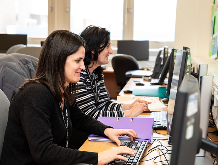 Students working on computers at desk